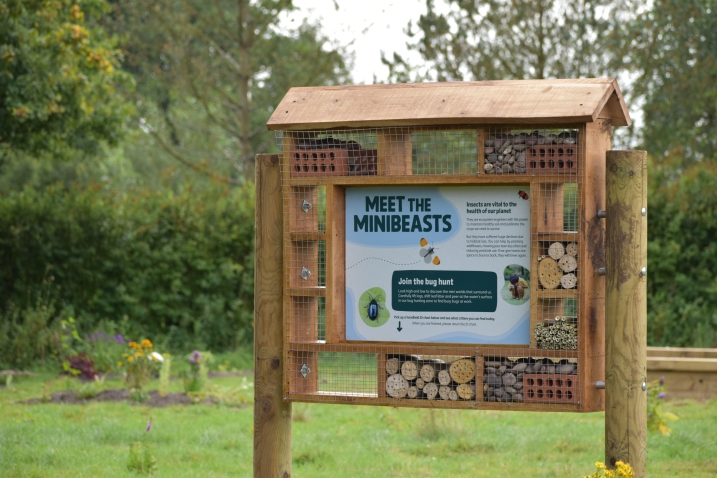 A sign made into a bug hotel which explains the bug hunting area at martin mere